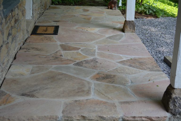 Inspiration for a mid-sized stone front porch remodel in Other with a roof extension by The Outdoor Living Studio | Outdoor Photos | Porch | Landscaping | Landscape Design | Outdoor Living Space | Porch Design Ideas | Outdoor Living Space Ideas | Backyard Design