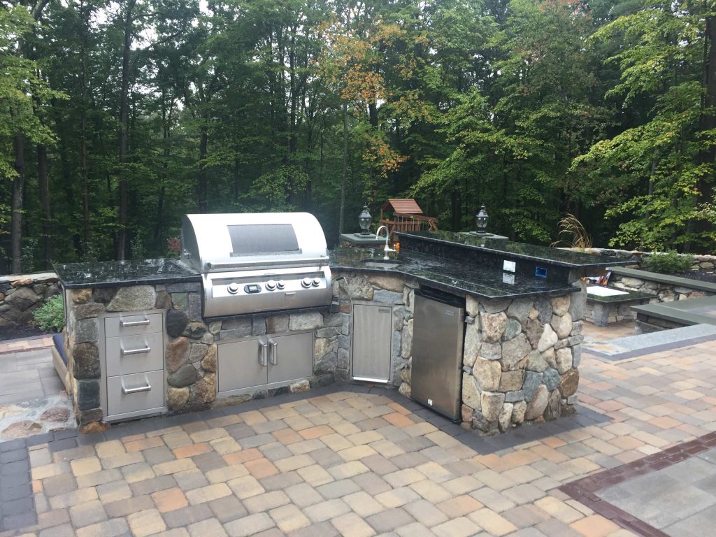 Inspiration for a mid-sized timeless backyard brick patio kitchen remodel in Boston with no cover