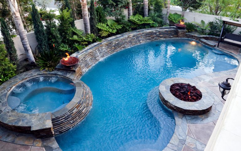 Inspiration for a mid-sized timeless backyard concrete and kidney-shaped lap hot tub remodel in Orange County