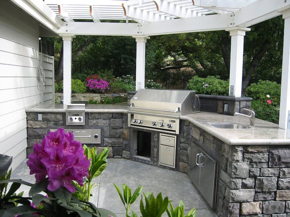 Inspiration for a mid-sized timeless backyard concrete patio kitchen remodel in San Francisco with a pergola