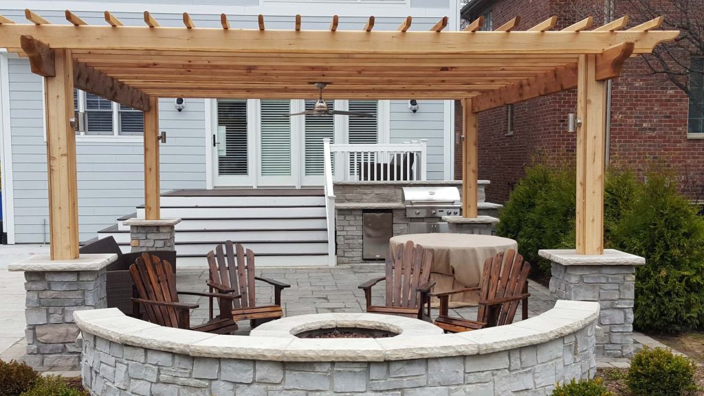 Inspiration for a mid-sized timeless backyard concrete paver patio kitchen remodel in Chicago with a pergola