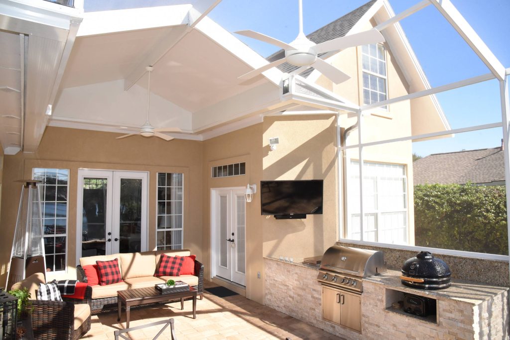 Inspiration for a mid-sized timeless backyard concrete paver patio kitchen remodel in Jacksonville with a roof extension