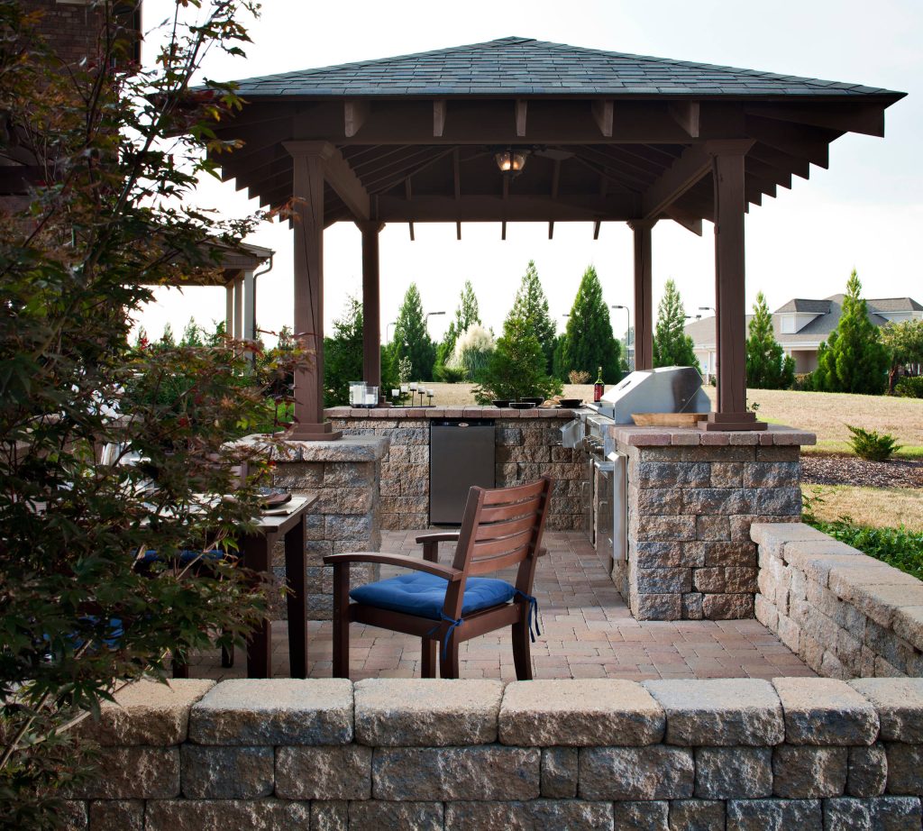 Inspiration for a mid-sized timeless backyard concrete paver patio kitchen remodel in New York with a gazebo