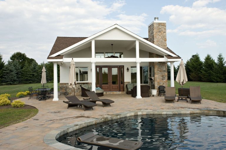 Inspiration for a mid-sized timeless backyard custom-shaped and concrete paver pool house remodel in New York