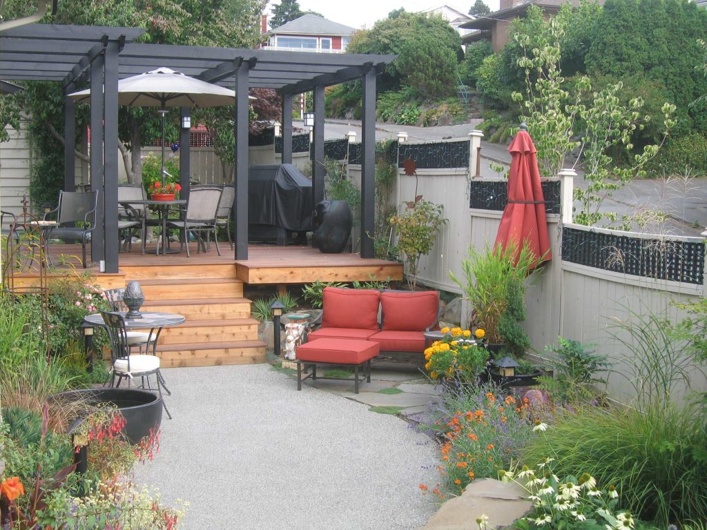 Inspiration for a mid-sized timeless backyard outdoor kitchen deck remodel in Seattle with a pergola
