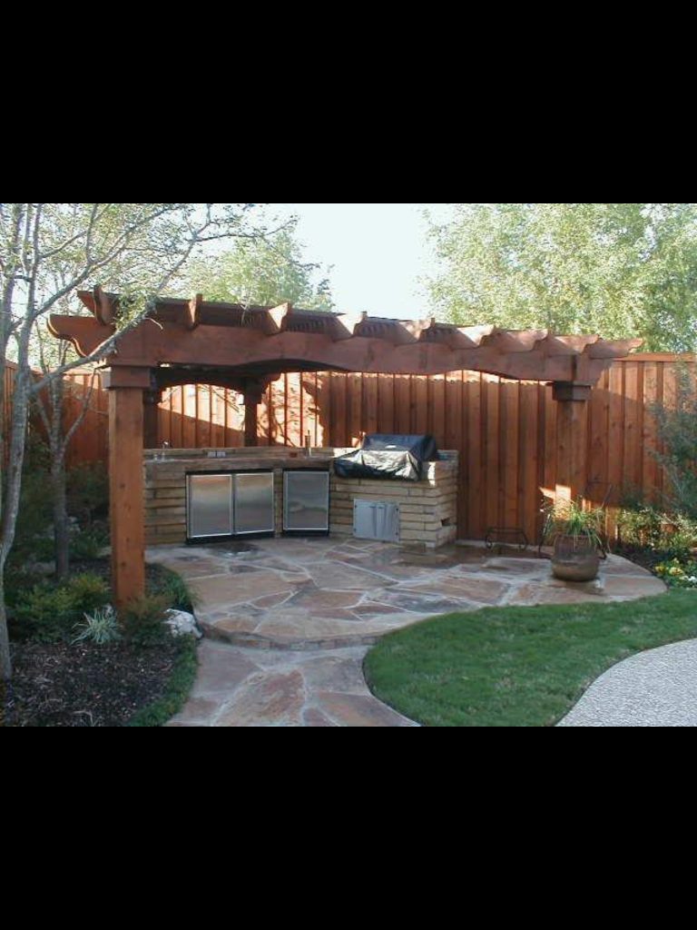 Inspiration for a mid-sized timeless backyard stamped concrete patio kitchen remodel in Dallas with a gazebo
