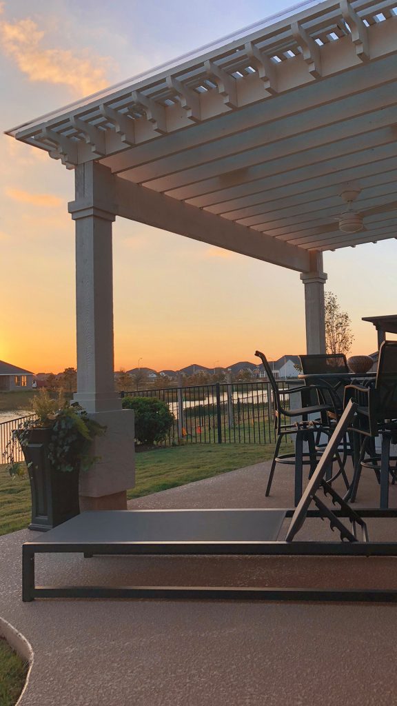 Inspiration for a mid-sized timeless backyard stamped concrete patio kitchen remodel in Houston with a pergola