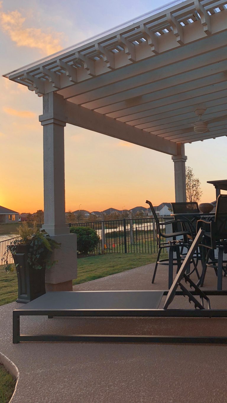 Inspiration for a mid-sized timeless backyard stamped concrete patio kitchen remodel in Houston with a pergola