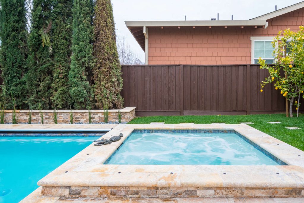 Inspiration for a mid-sized timeless backyard stone and rectangular lap hot tub remodel in San Francisco