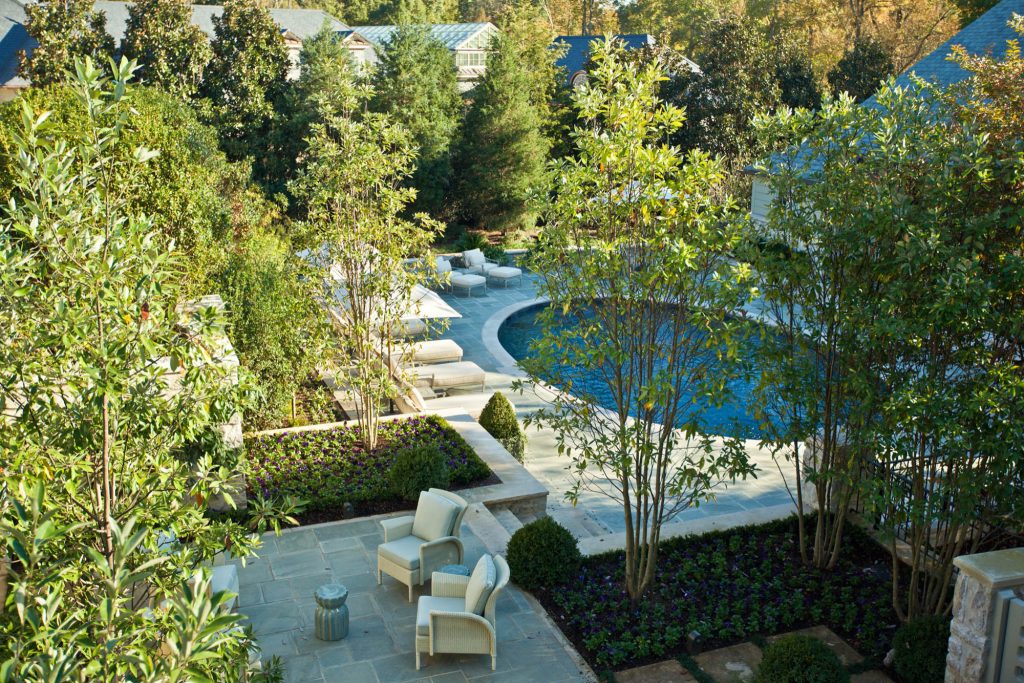 Inspiration for a mid-sized timeless backyard stone patio kitchen remodel in Charlotte with a roof extension