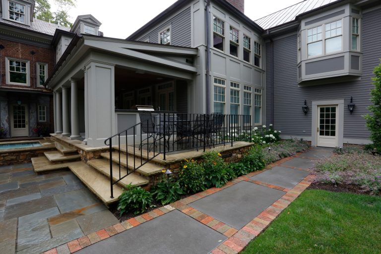 Inspiration for a mid-sized timeless backyard stone patio kitchen remodel in Cleveland with a roof extension