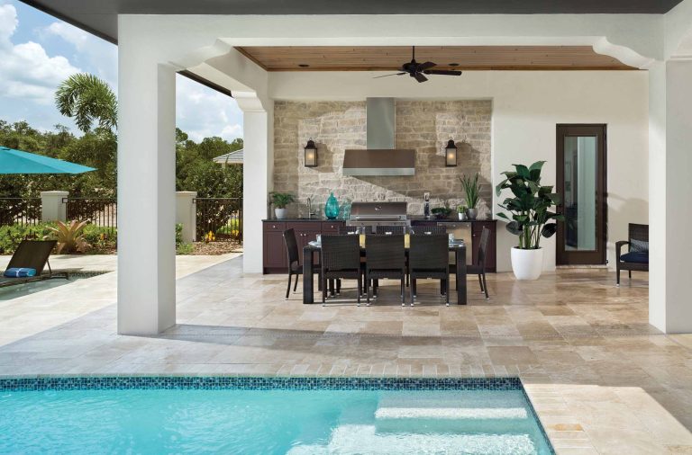Inspiration for a mid-sized timeless backyard stone patio kitchen remodel in Orlando with a roof extension