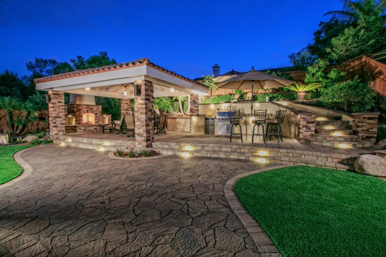 Inspiration for a mid-sized timeless backyard stone patio kitchen remodel in San Diego with a gazebo