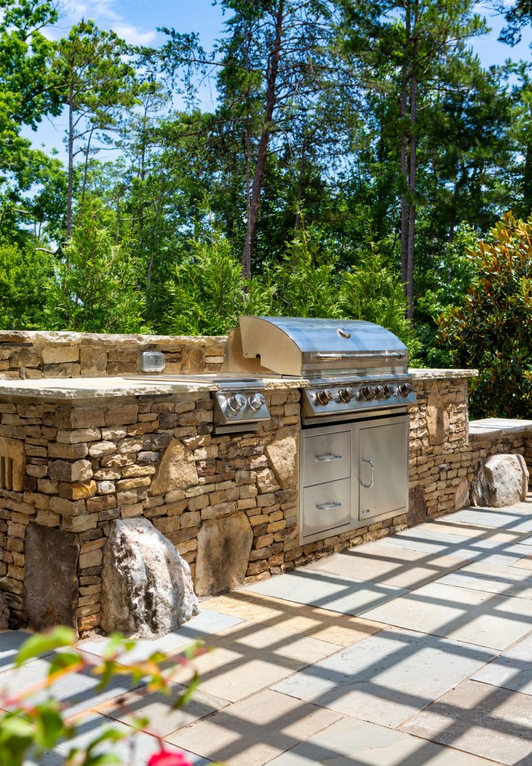Inspiration for a mid-sized timeless backyard tile patio kitchen remodel in Charlotte with a pergola