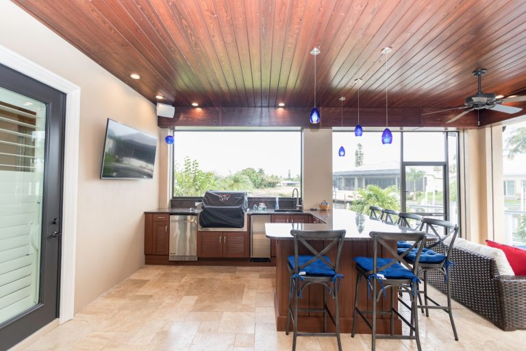 Inspiration for a mid-sized timeless backyard tile patio kitchen remodel in Miami with a roof extension