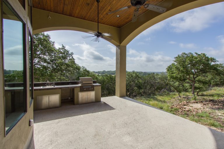 Inspiration for a mid-sized timeless concrete porch remodel in Austin with a roof extension