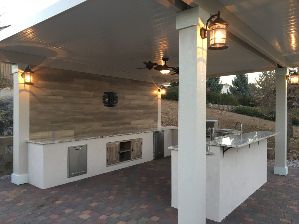 Inspiration for a mid-sized timeless side yard brick patio kitchen remodel in Other with a gazebo