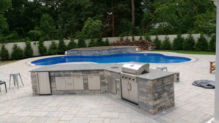 Inspiration for a mid-sized transitional backyard concrete paver and custom-shaped pool remodel in Orange County