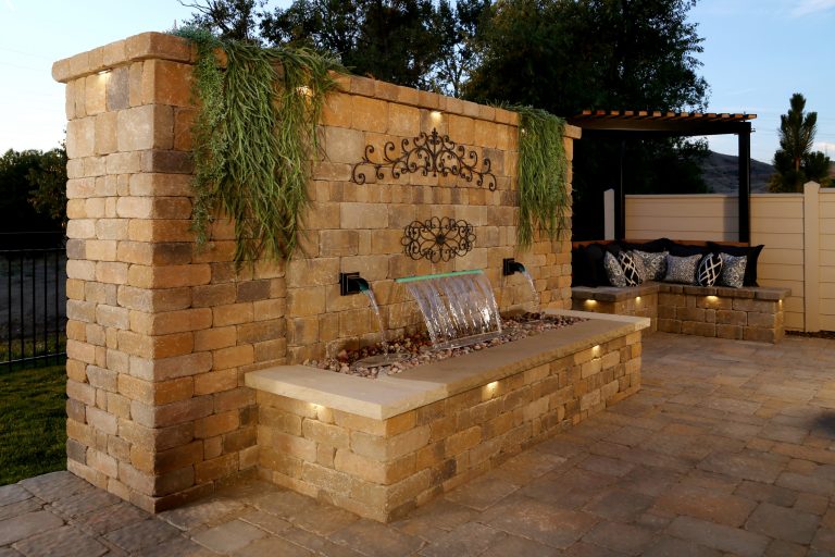 Inspiration for a mid-sized transitional backyard concrete paver patio kitchen remodel in Boise with a pergola