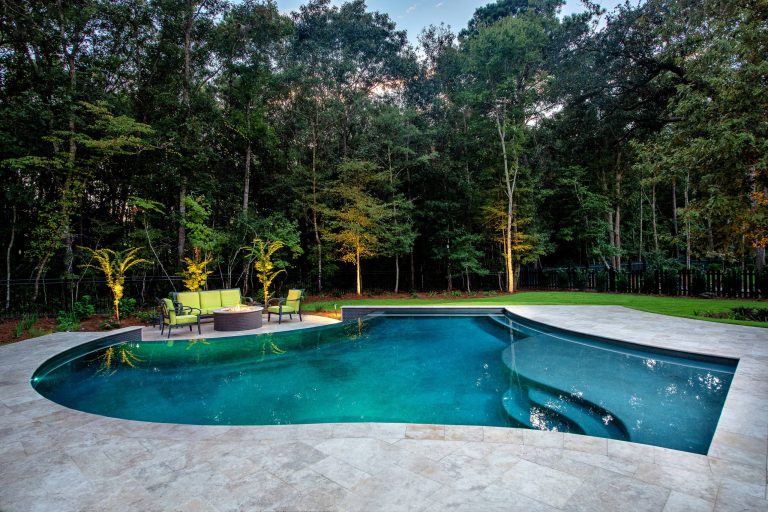 Inspiration for a mid-sized transitional backyard stone and custom-shaped infinity pool remodel in Charleston