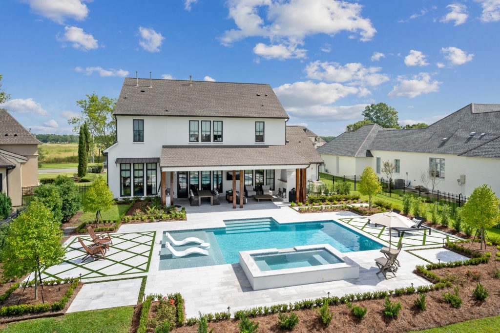 Inspiration for a mid-sized transitional backyard stone and custom-shaped pool landscaping remodel in New Orleans