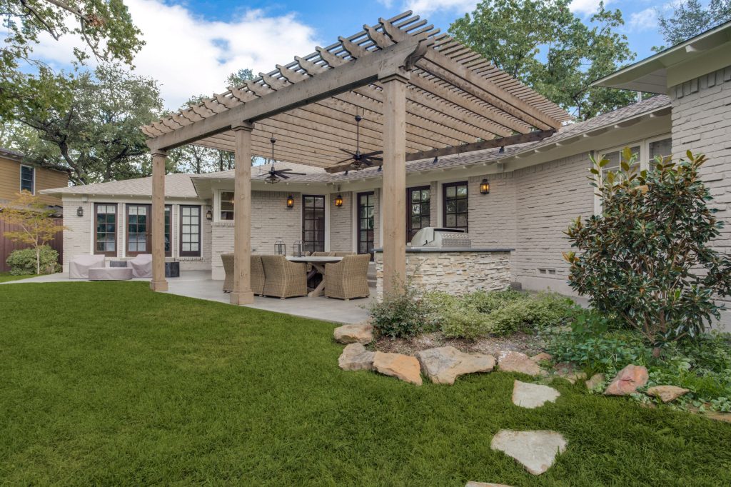 Inspiration for a mid-sized transitional concrete porch remodel in Dallas with a pergola