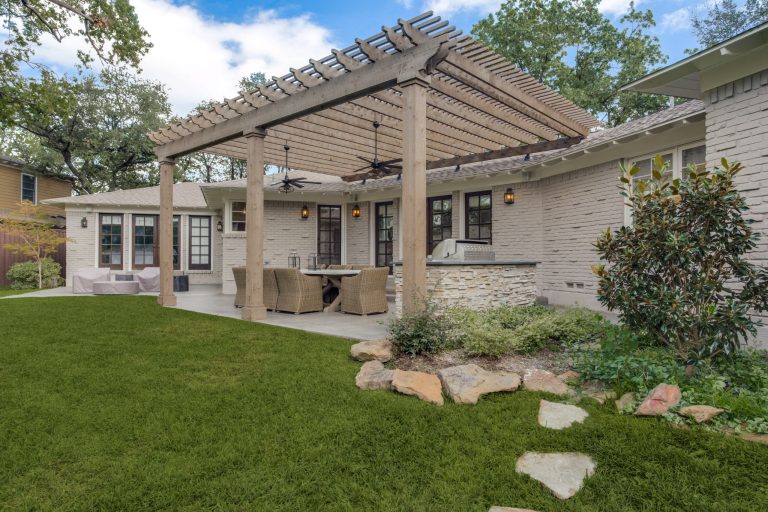 Inspiration for a mid-sized transitional concrete porch remodel in Dallas with a pergola