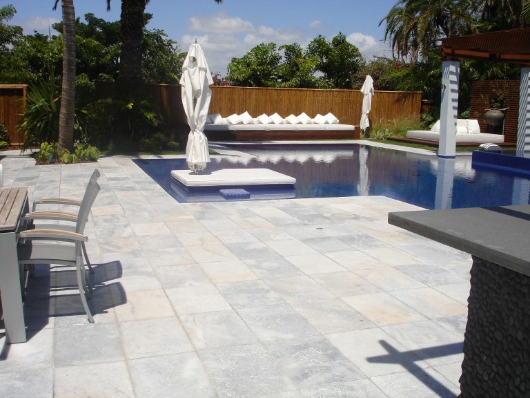 Inspiration for a mid-sized tropical backyard brick and custom-shaped hot tub remodel in Miami