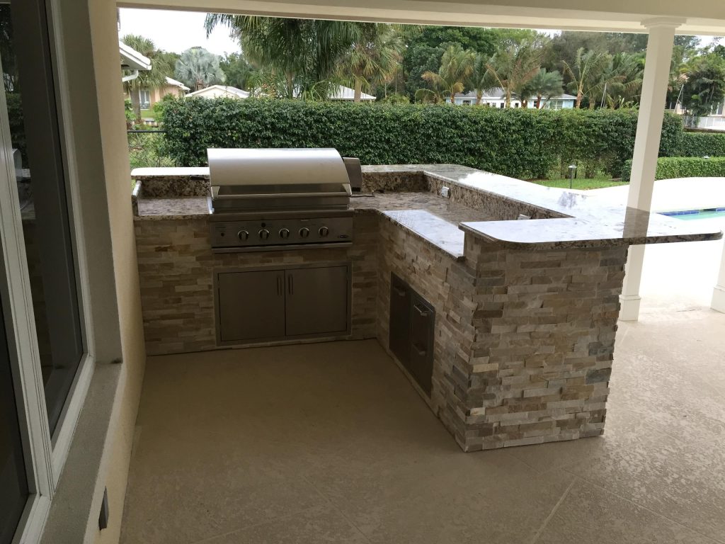 Inspiration for a mid-sized tropical backyard concrete patio kitchen remodel in Miami with a roof extension