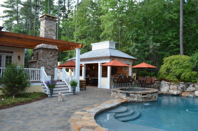 Inspiration for a mid-sized tropical backyard stone and custom-shaped lap hot tub remodel in Atlanta