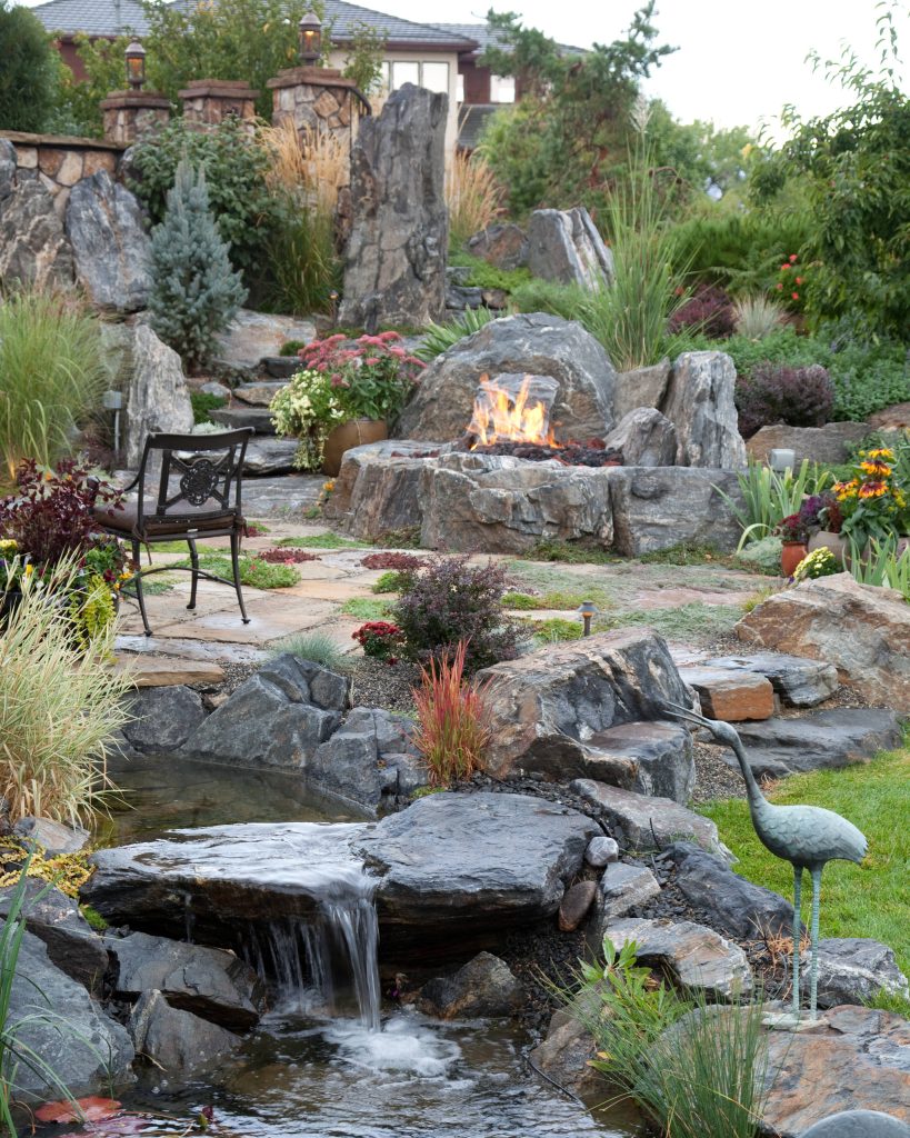 Inspiration for a mid-sized mediterranean full sun backyard stone landscaping in Denver.