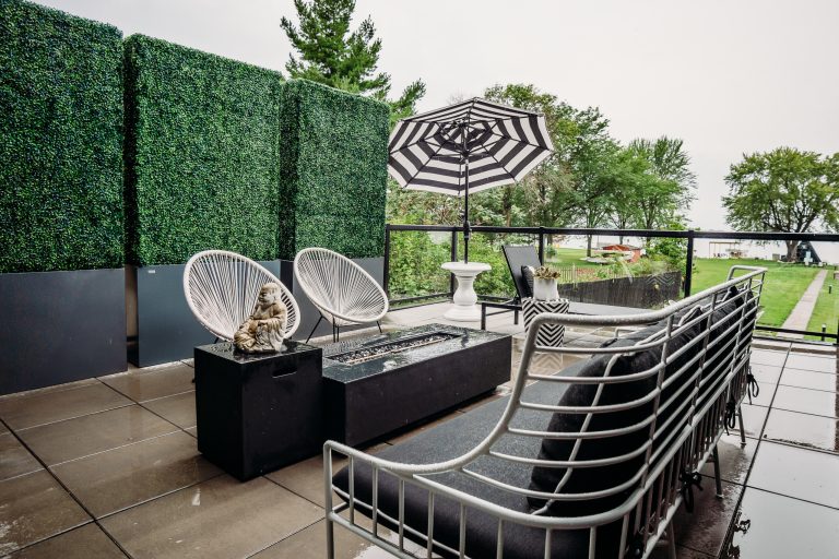 Inspiration for a modern concrete back porch remodel in Other with a fire pit and a roof extension by Mader Designs | Outdoor Photos | Porch | Landscaping | Landscape Design | Outdoor Living Space | Porch Design Ideas | Outdoor Living Space Ideas | Backyard Design