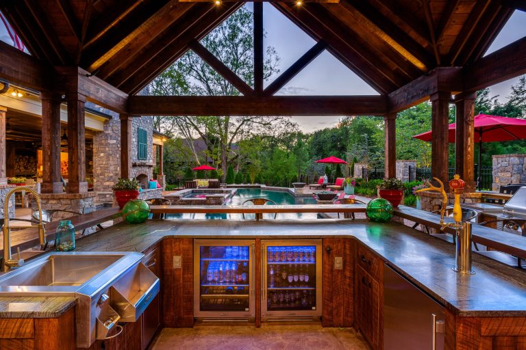 Inspiration for a rustic backyard patio kitchen remodel in Nashville with a gazebo