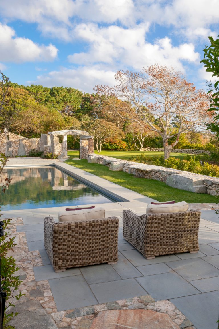 Inspiration for a rustic backyard stamped concrete and rectangular lap pool remodel in Boston