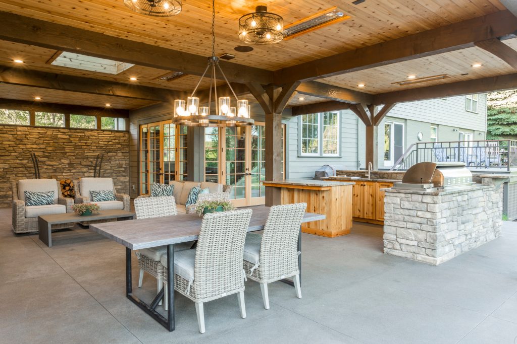 Inspiration for a rustic concrete patio kitchen remodel in Portland with a roof extension