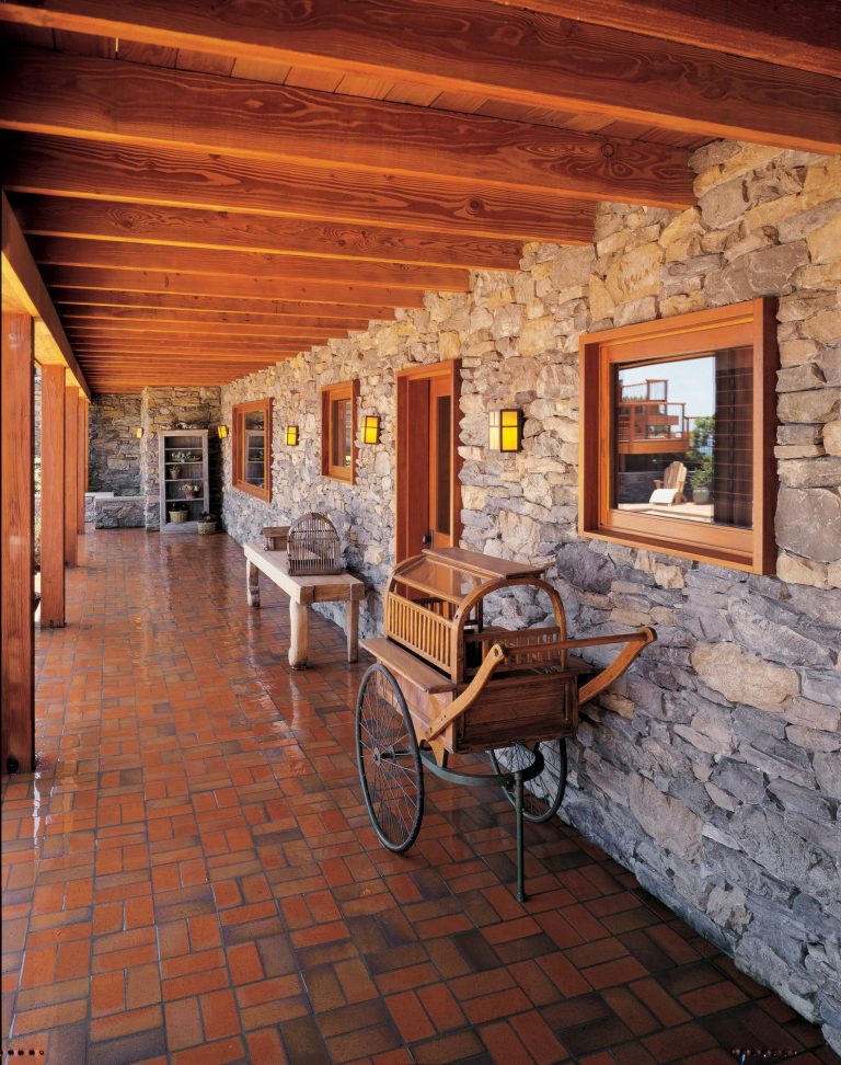 Inspiration for a rustic tile porch remodel in San Diego with a roof extension by Eldorado Stone | Outdoor Photos | Porch | Landscaping | Landscape Design | Outdoor Living Space | Porch Design Ideas | Outdoor Living Space Ideas | Backyard Design