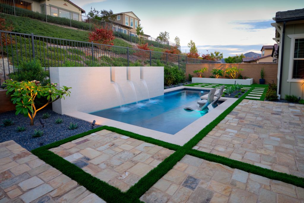 Inspiration for a small contemporary backyard stone and rectangular hot tub remodel in Orange County