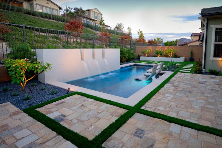 Inspiration for a small contemporary backyard stone and rectangular hot tub remodel in Orange County