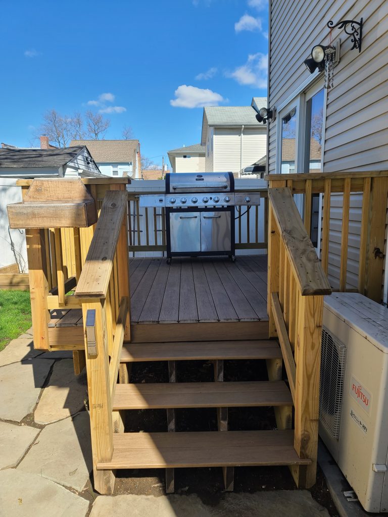 Inspiration for a small modern backyard stone patio kitchen remodel in New York with no cover