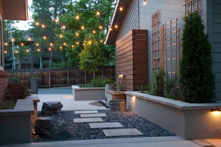 Inspiration for a small modern partial sun backyard stone landscaping in Denver.
