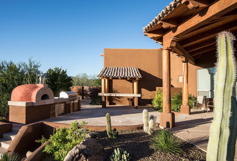 Inspiration for a small southwestern backyard stone patio kitchen remodel in Phoenix