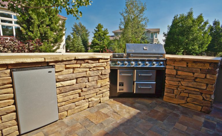 Inspiration for a small timeless backyard brick patio kitchen remodel in Denver with no cover