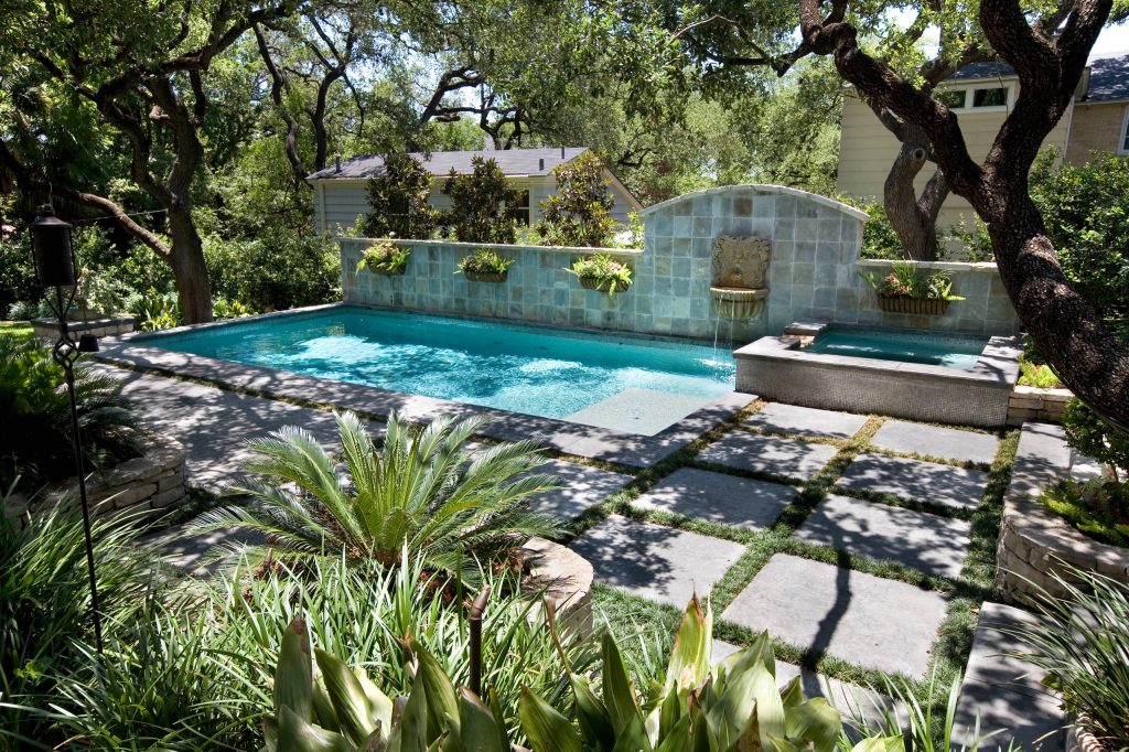 Inspiration for a small timeless backyard rectangular and stone lap pool fountain remodel in Austin