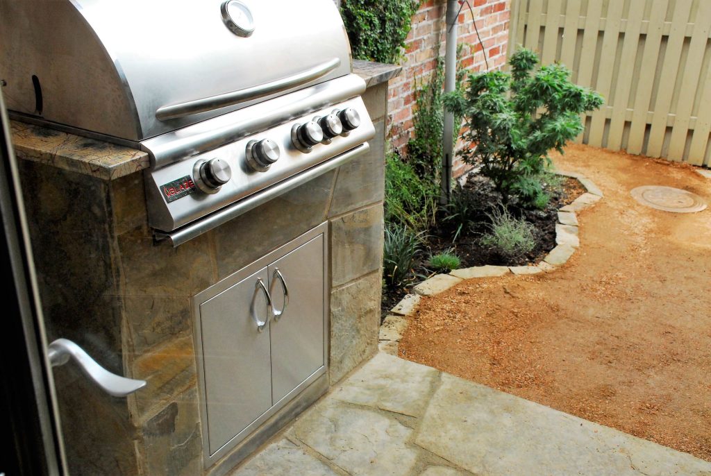 Inspiration for a small timeless backyard stone patio kitchen remodel in Dallas with no cover