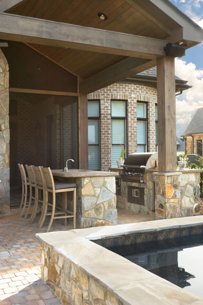 Inspiration for a small timeless backyard stone patio kitchen remodel in Other