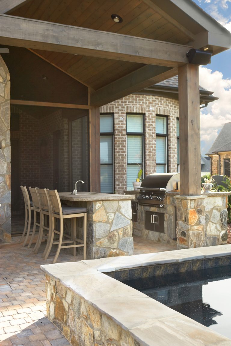 Inspiration for a small timeless backyard stone patio kitchen remodel in Other