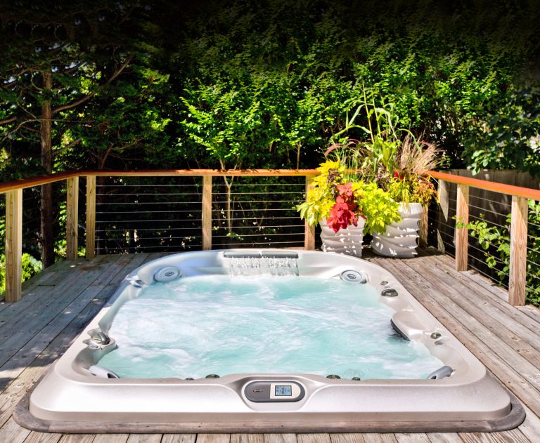Inspiration for a small tropical backyard rectangular aboveground hot tub remodel in Tampa with decking