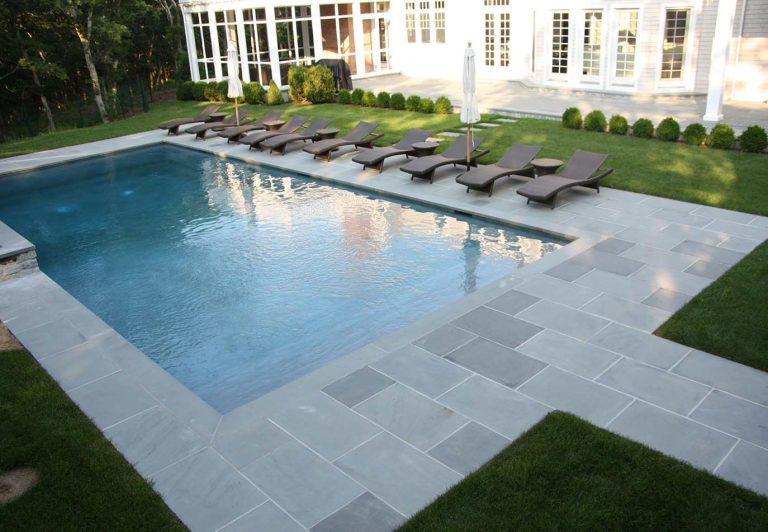Inspiration for a timeless backyard stamped concrete and rectangular pool remodel in New York