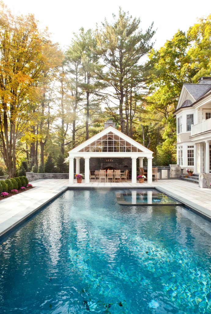 Inspiration for a timeless backyard stone and rectangular lap pool house remodel in New York