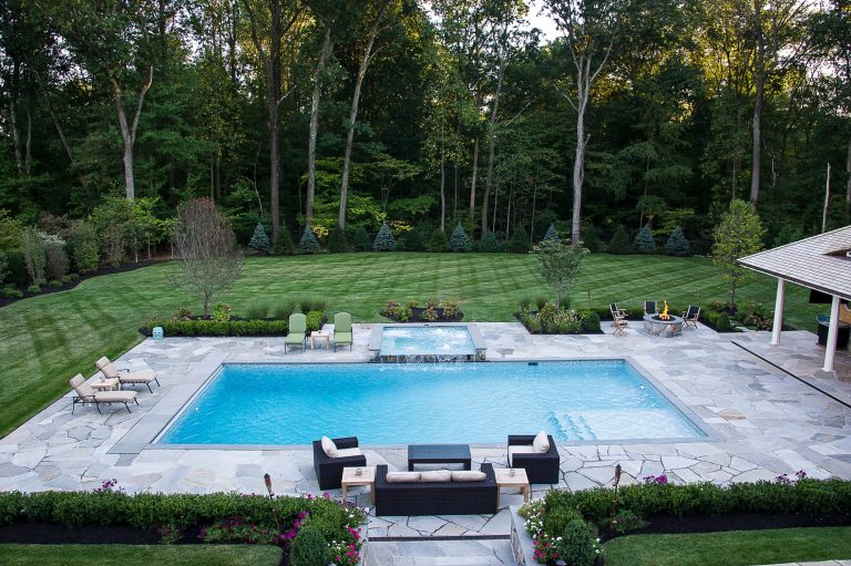 Inspiration for a timeless backyard stone and rectangular natural hot tub remodel in New York